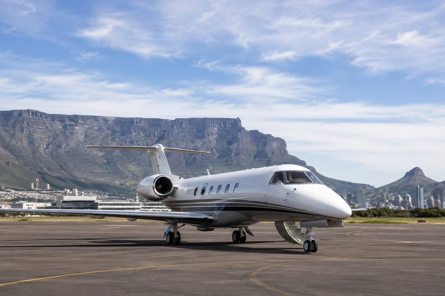 A business jet on the apron with Table Mountain behind it, Cape Town