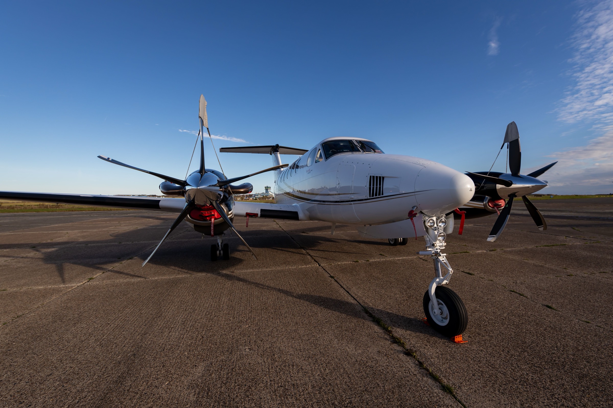 Twin-engine propeller aircraft parked on the apron
