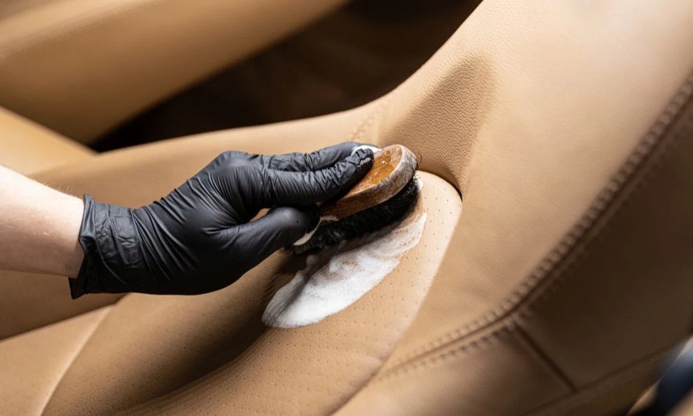 Leather aircraft seat being cleaned by hand